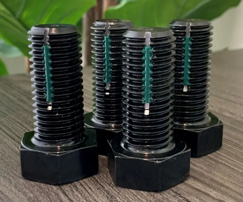 7/8"-9 UNC-2A x 2" Fully Threaded Hex Cap Screw in ASTM A193 Grade B7, black oxide per MIL-DTL-13924 Class 1, green Longlok — machined by Innovation Fasteners, Houston